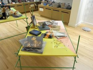 Image of Table with popular merchandise selected by the artist from the Frye Store, from the series Liu Ding's Store